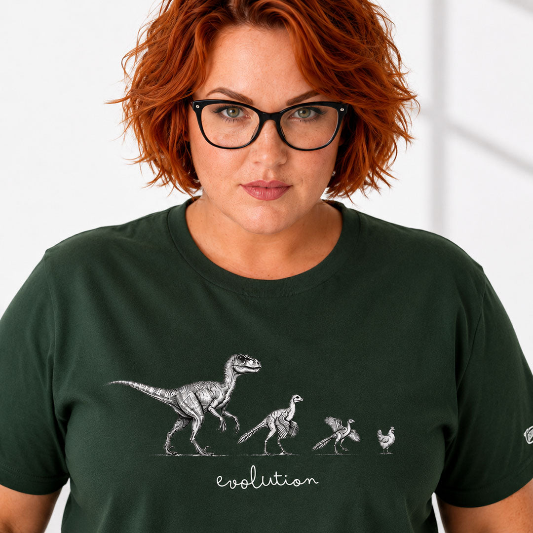 Person wearing a green t-shirt with dinosaur evolution graphic