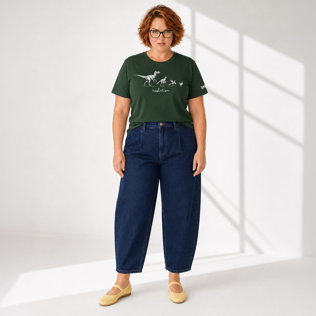Person wearing a green t-shirt with a graphic design and blue jeans on a white background