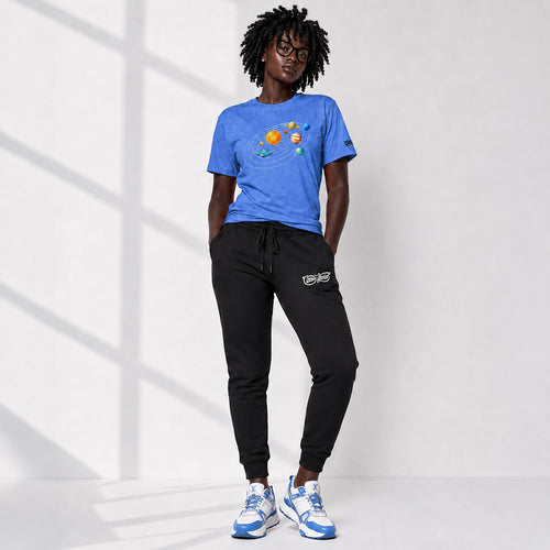 Person wearing a blue t-shirt with planet designs and black pants on a white background