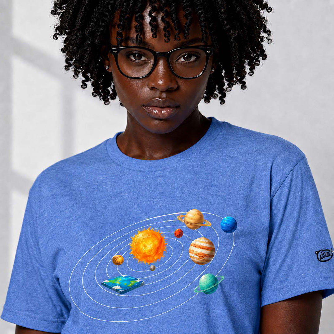 Person wearing a blue t-shirt with a solar system design on a plain background