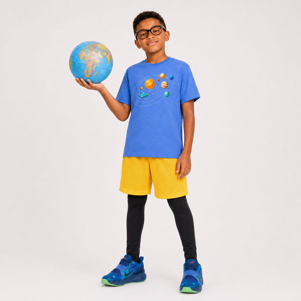 Child holding a small globe wearing a blue t-shirt with solar system design on a plain background