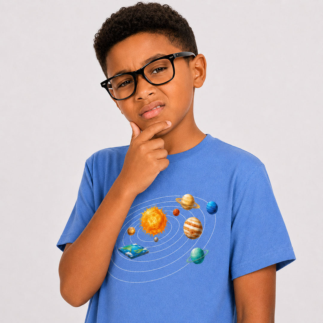 Child wearing a blue t-shirt with a solar system design on a plain background