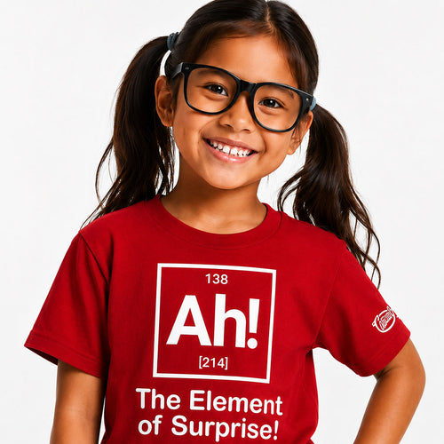 Child wearing a red t-shirt with a humorous element-themed design on a plain background