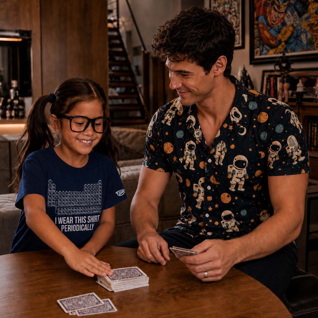 Dad and young girl playing cards together in a cozy room.