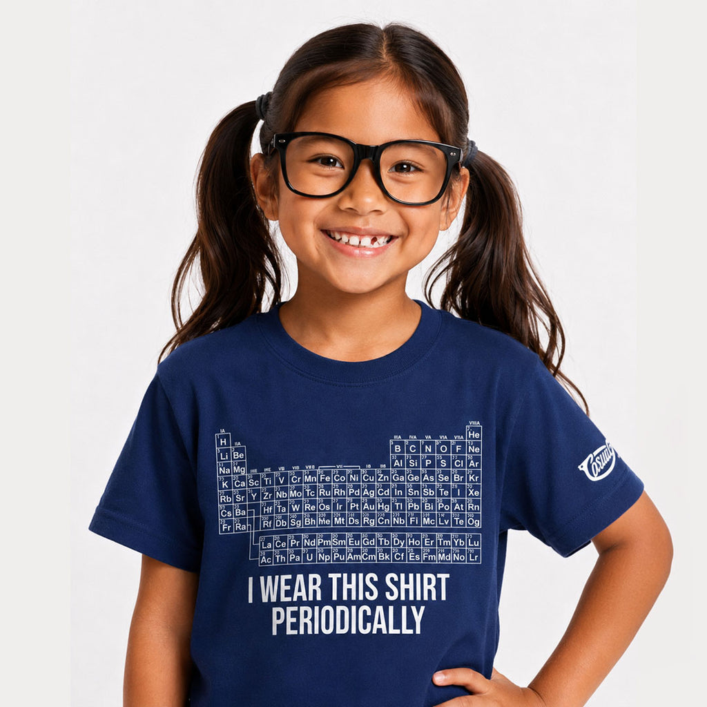 Young girl wearing a navy blue t-shirt with a periodic table design and text on a white background