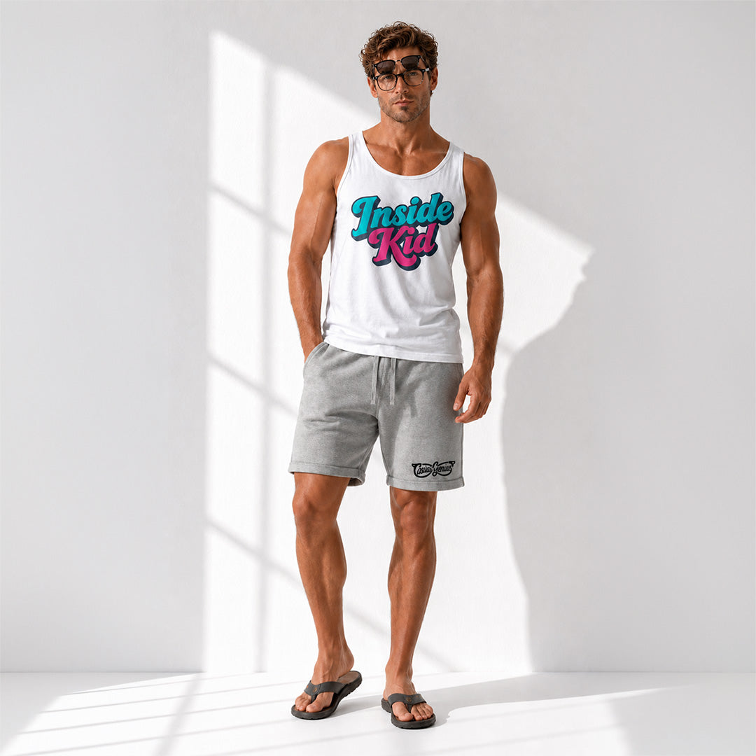 A man modeling a white tank top with a colorful 'Inside Rait' graphic and gray shorts in a bright, sunlit studio setting.