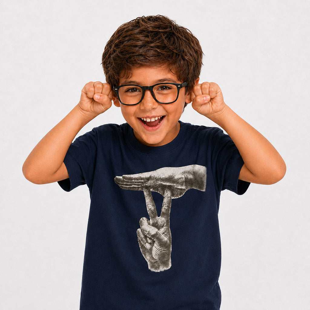 A young boy with brown hair and glasses wearing a navy blue t-shirt with a black and white graphic of a hand, posing with his fists raised against a light gray background to make the ASL SEARS joke.